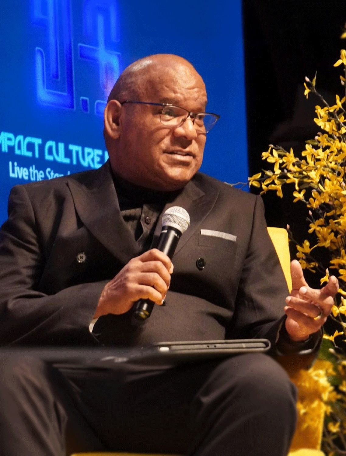 Apostle Joseph L. Stanford speaking from the stage