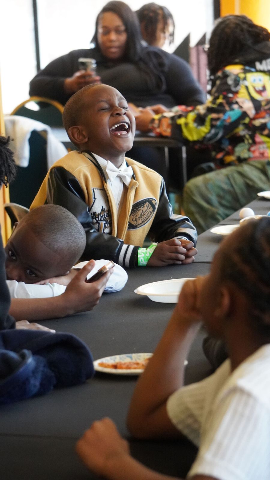 A young boy laughing at an ICN gathering
